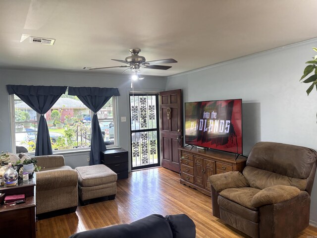 1222 Hendrix Ave, Little Rock, AR 72204 - living room with light wood finished floors, a ceiling fan, and ornamental molding