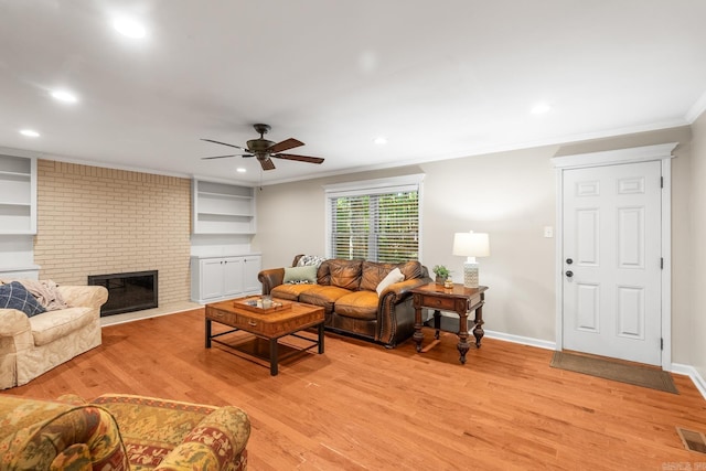 8 Cannon Ct, Little Rock, AR 72212 - living room with light wood-type flooring, ornamental molding, a ceiling fan, recessed lighting, and a brick fireplace