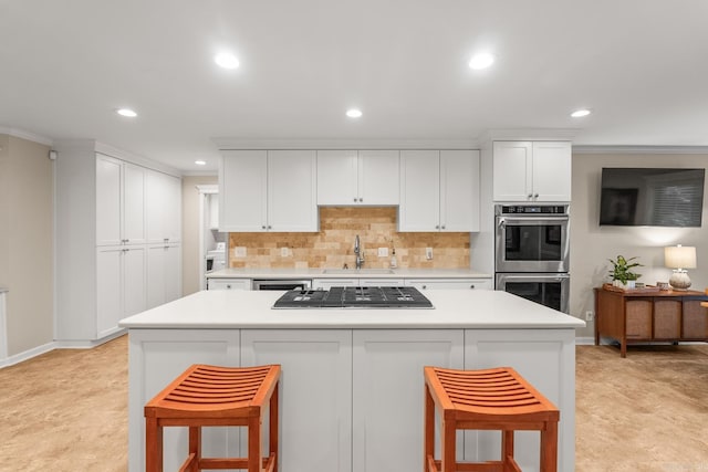 8 Cannon Ct, Little Rock, AR 72212 - kitchen with stainless steel appliances, a sink, recessed lighting, a center island, and white cabinetry