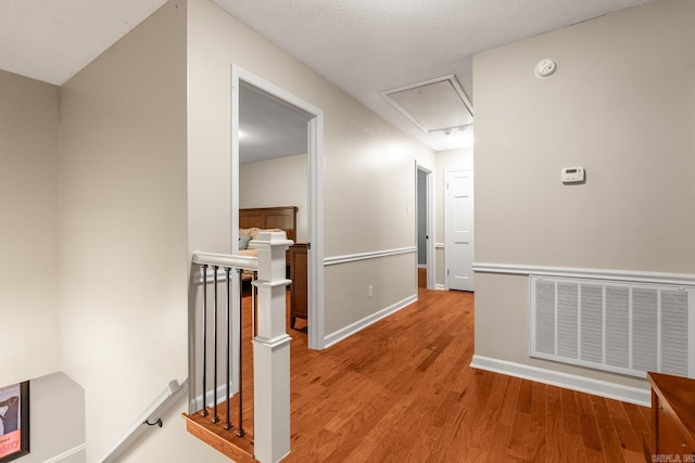 8 Cannon Ct, Little Rock, AR 72212 - corridor featuring an upstairs landing, attic access, light wood-style floors, and baseboards