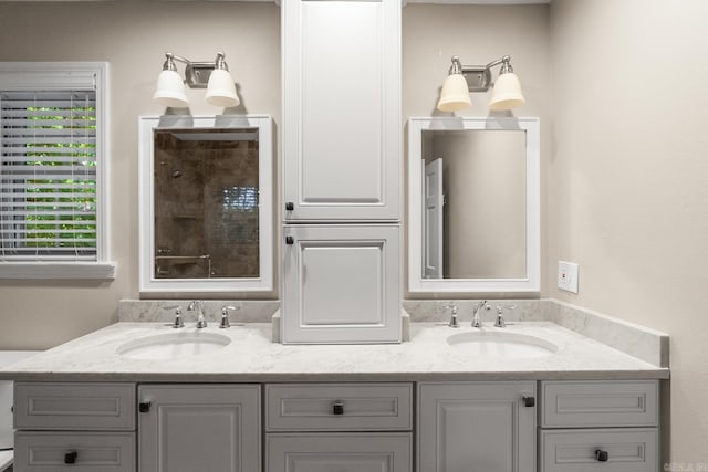 8 Cannon Ct, Little Rock, AR 72212 - bathroom featuring double vanity, a tile shower, and healthy amount of natural light