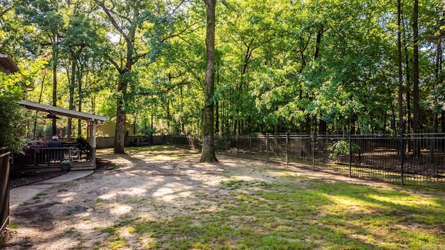 8 Cannon Ct, Little Rock, AR 72212 - view of yard featuring fence, a wooden deck, and a forest view