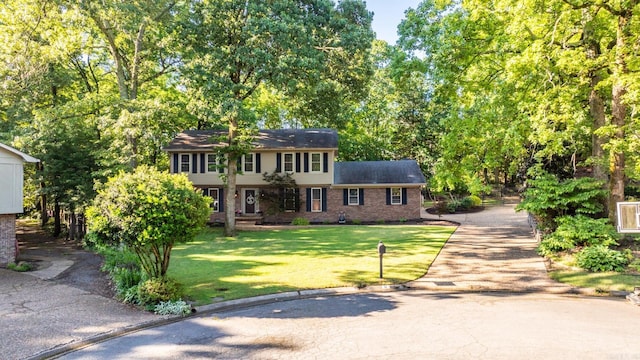 8 Cannon Ct, Little Rock, AR 72212 - colonial inspired home with brick siding, a front lawn, and asphalt driveway