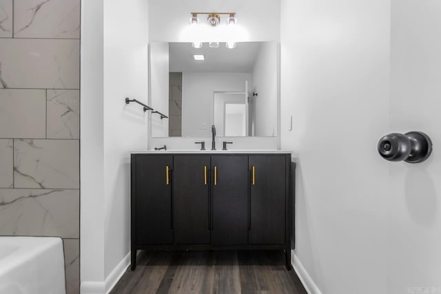 716 Vinson, Little Rock, AR 72205 - full bath featuring wood finished floors, baseboards, a bath, and double vanity