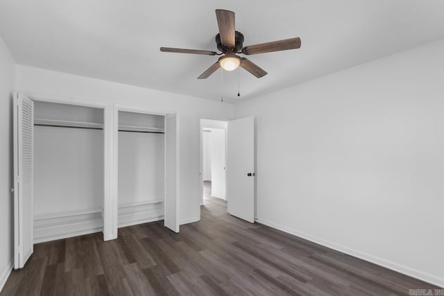 716 Vinson, Little Rock, AR 72205 - unfurnished bedroom with two closets, dark wood-style flooring, baseboards, and ceiling fan