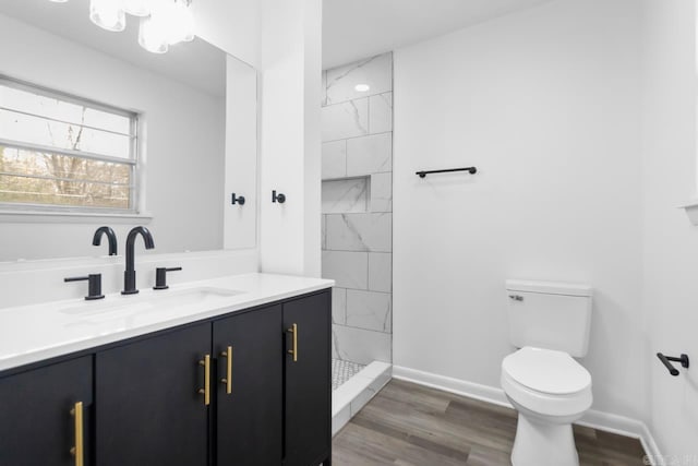 716 Vinson, Little Rock, AR 72205 - full bathroom with toilet, vanity, a tile shower, baseboards, and wood finished floors