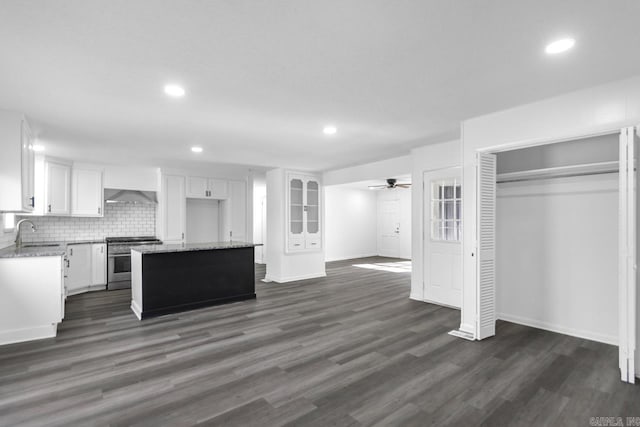 716 Vinson, Little Rock, AR 72205 - kitchen with stainless steel gas range oven, exhaust hood, white cabinets, recessed lighting, and a center island