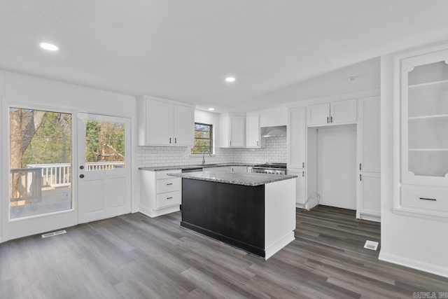 716 Vinson, Little Rock, AR 72205 - kitchen featuring dark wood-type flooring, white cabinetry, backsplash, a center island, and recessed lighting