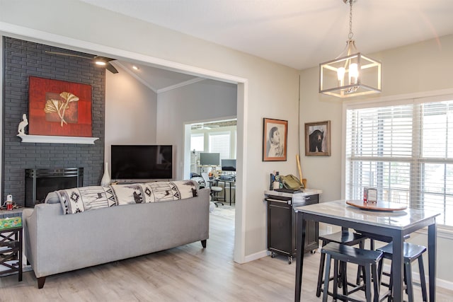 47 Lakeview Rd, Houston, AR 72070 - living room with a chandelier, light wood finished floors, baseboards, a brick fireplace, and crown molding