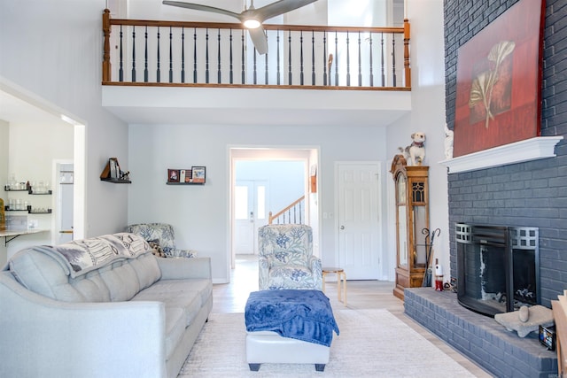 47 Lakeview Rd, Houston, AR 72070 - living area featuring a high ceiling, wood finished floors, a brick fireplace, a ceiling fan, and baseboards