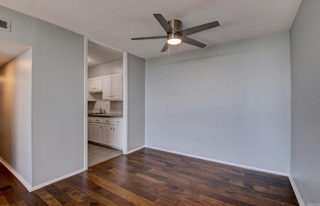 700 E 9th St Unit 9A, Little Rock, AR 72202 - spare room with wood finished floors, a textured ceiling, ceiling fan, a sink, and baseboards