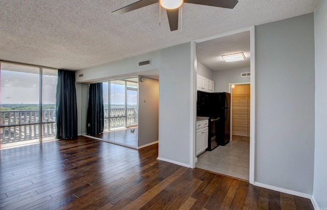 700 E 9th St Unit 9A, Little Rock, AR 72202 - spare room with a textured ceiling, ceiling fan, wood-type flooring, and baseboards