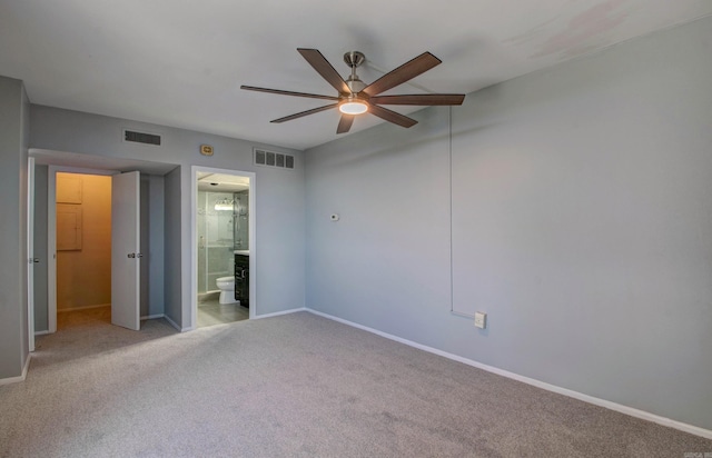 700 E 9th St Unit 9A, Little Rock, AR 72202 - unfurnished bedroom featuring carpet, baseboards, ensuite bath, and ceiling fan