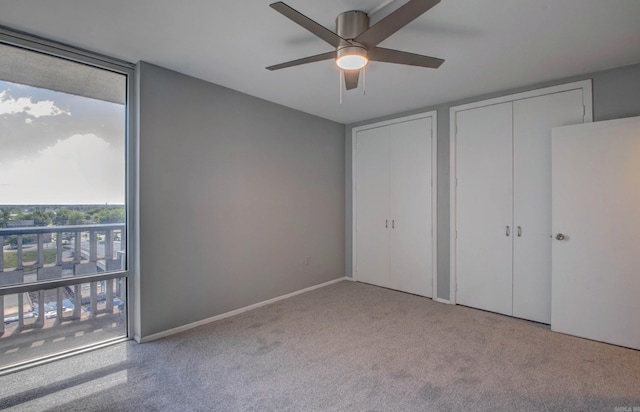 700 E 9th St Unit 9A, Little Rock, AR 72202 - unfurnished bedroom featuring carpet floors, multiple closets, and ceiling fan