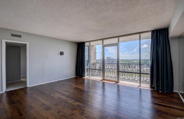 700 E 9th St Unit 9A, Little Rock, AR 72202 - spare room featuring floor to ceiling windows, hardwood / wood-style flooring, a textured ceiling, and baseboards