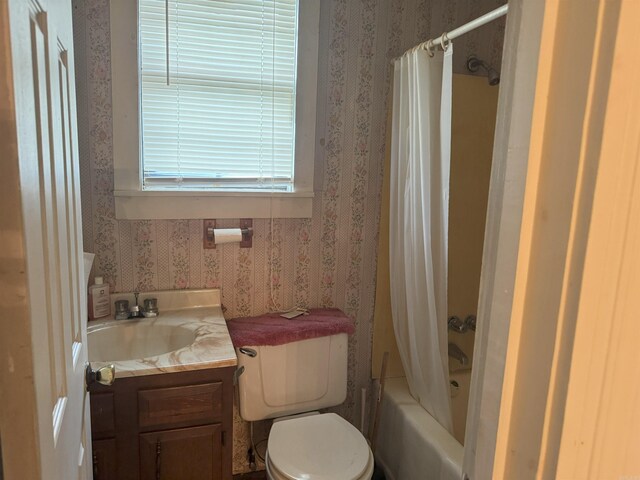 bathroom with wallpapered walls, vanity, toilet, and shower / bath combo