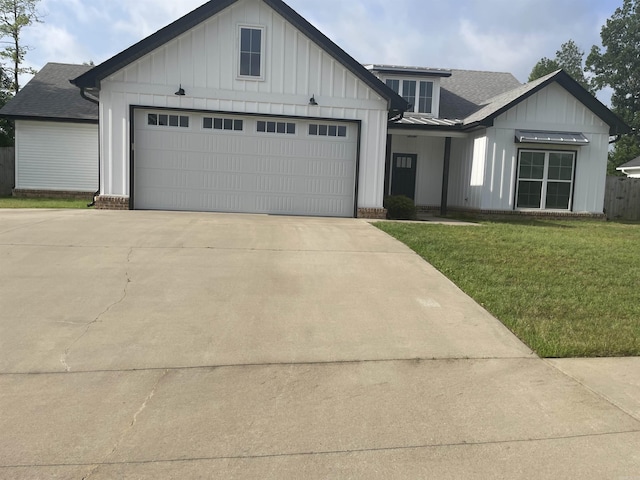 2009 Berkshire Dr, Benton, AR 72019 - modern inspired farmhouse with board and batten siding, driveway, a front yard, and roof with shingles