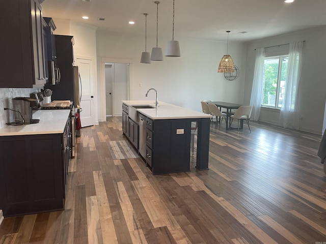 2009 Berkshire Dr, Benton, AR 72019 - kitchen featuring appliances with stainless steel finishes, light countertops, dark wood finished floors, dark cabinets, and a sink