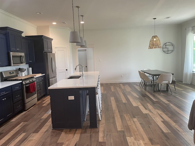 2009 Berkshire Dr, Benton, AR 72019 - kitchen with stainless steel appliances, a sink, light countertops, dark wood-style floors, and ornamental molding