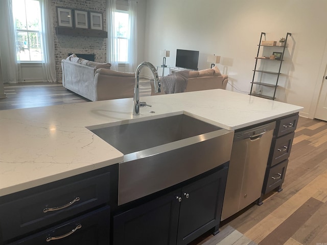 2009 Berkshire Dr, Benton, AR 72019 - kitchen featuring open floor plan, dark cabinets, and light wood-style floors