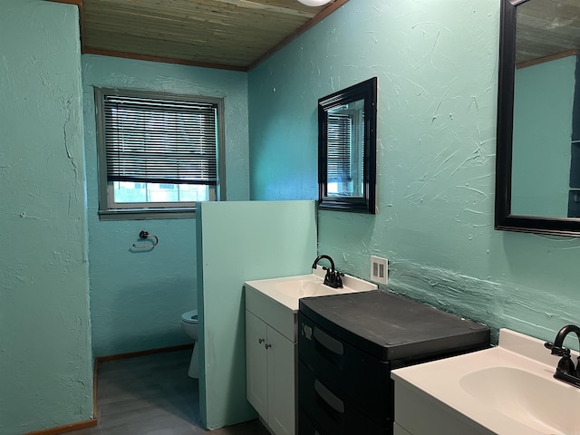 600 King St, Searcy, AR 72143 - bathroom with wood ceiling, two vanities, a textured wall, toilet, and wood finished floors