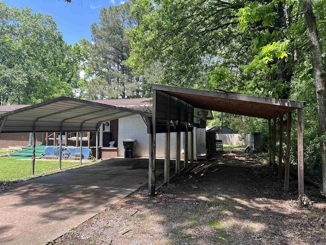 600 King St, Searcy, AR 72143 - view of parking featuring concrete driveway and a detached carport