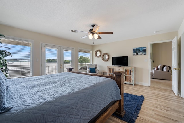 110 Jamison Ln, Hot Springs, AR 71913 - bedroom featuring access to outside, light wood-type flooring, baseboards, a ceiling fan, and a textured ceiling