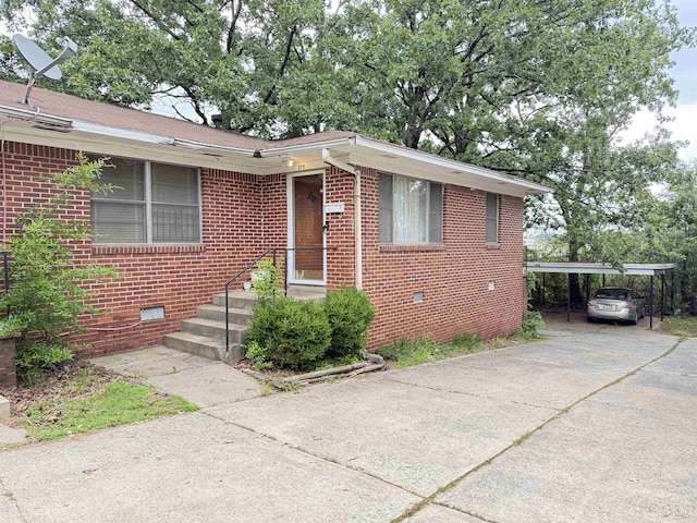 215217 N Pierce St, Little Rock, AR 72205 - bungalow-style home with crawl space, brick siding, a carport, and driveway