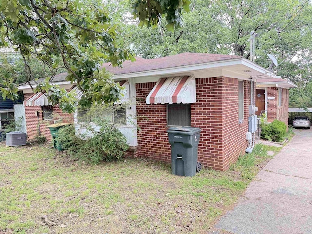 215217 N Pierce St, Little Rock, AR 72205 - view of home's exterior featuring brick siding and cooling unit