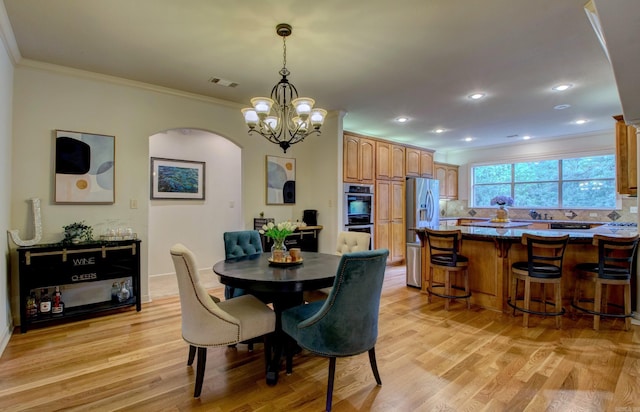 32 Bronte Ct, Little Rock, AR 72223 - dining area with arched walkways, ornamental molding, light wood-type flooring, a chandelier, and recessed lighting