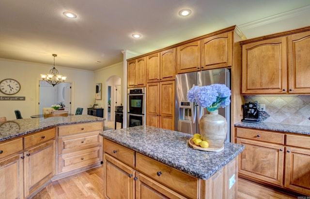 32 Bronte Ct, Little Rock, AR 72223 - kitchen featuring appliances with stainless steel finishes, arched walkways, light wood-type flooring, a chandelier, and dark stone countertops