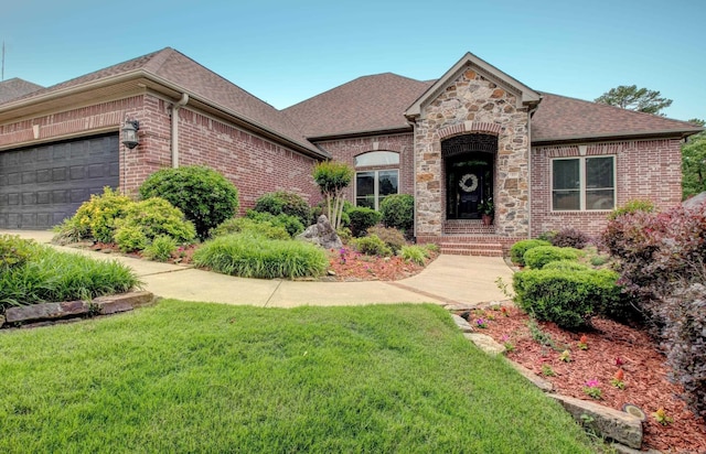 32 Bronte Ct, Little Rock, AR 72223 - french country style house featuring brick siding, a front yard, roof with shingles, and an attached garage
