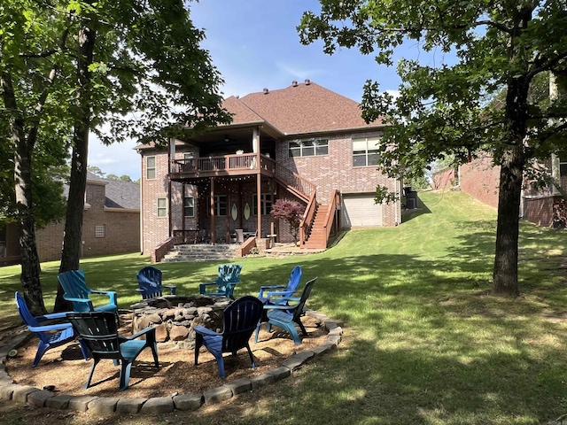32 Bronte Ct, Little Rock, AR 72223 - rear view of house with a fire pit, stairs, brick siding, a deck, and a lawn