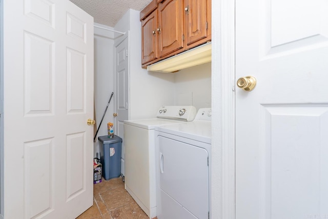 2616 Stallings Ln, Jonesboro, AR 72401 - washroom featuring cabinet space, washing machine and dryer, a textured ceiling, and light stone finish floors