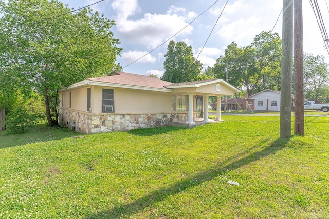 2616 Stallings Ln, Jonesboro, AR 72401 - rear view of property with stone siding, a lawn, stucco siding, and roof with shingles