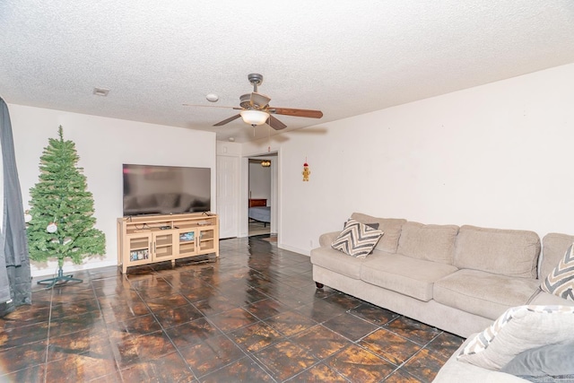 2616 Stallings Ln, Jonesboro, AR 72401 - living area with a ceiling fan, a textured ceiling, and baseboards