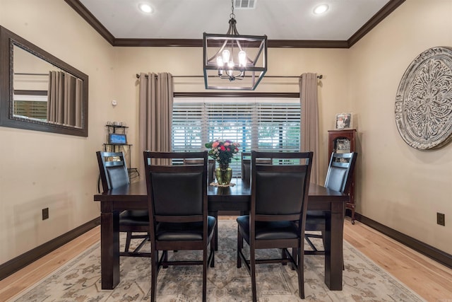 dining space with a chandelier, ornamental molding, light wood-style floors, baseboards, and recessed lighting