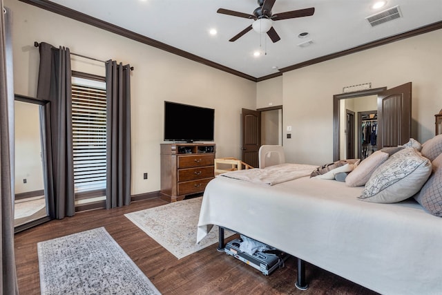 bedroom featuring ornamental molding, dark wood-style flooring, baseboards, recessed lighting, and a spacious closet