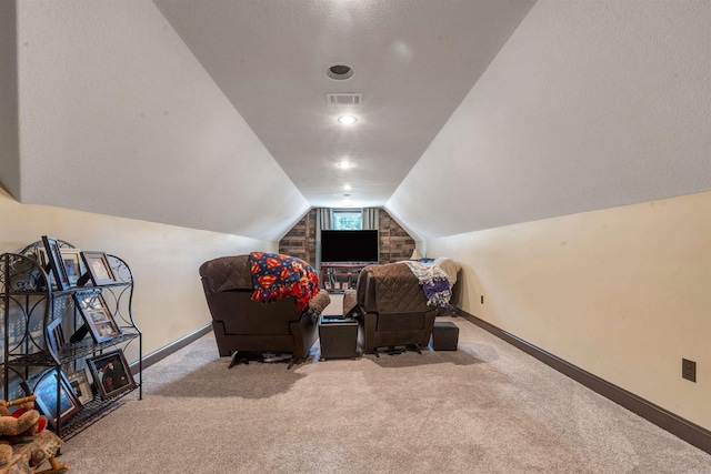 living area featuring carpet flooring, baseboards, lofted ceiling, and a textured ceiling