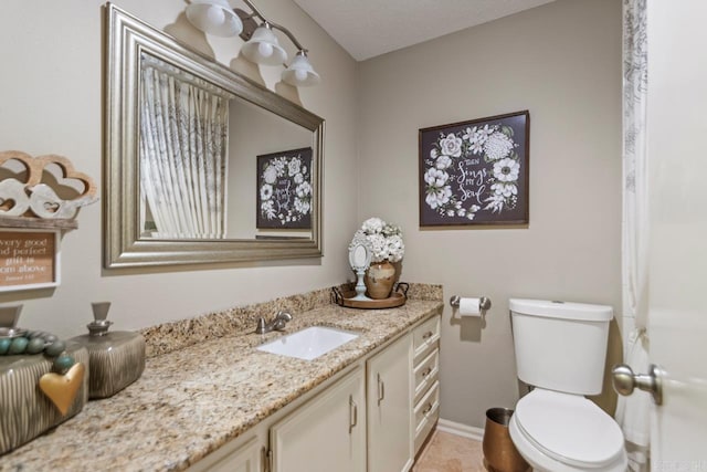 3311 Hazy Ridge Ct, Little Rock, AR 72227 - bathroom with vanity, toilet, and baseboards