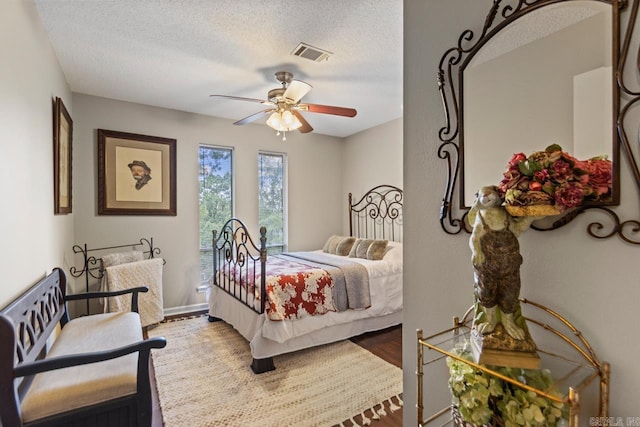 3311 Hazy Ridge Ct, Little Rock, AR 72227 - bedroom featuring a textured ceiling, wood finished floors, and a ceiling fan