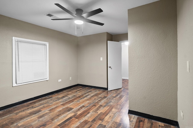 503 N Walnut St, Searcy, AR 72143 - spare room featuring wood finished floors, a ceiling fan, a textured wall, and baseboards