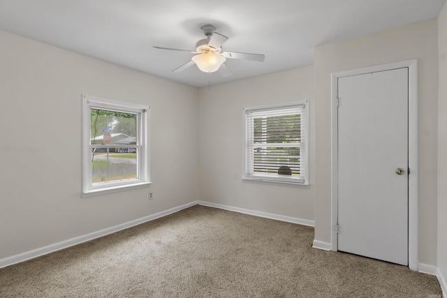 503 N Walnut St, Searcy, AR 72143 - empty room featuring healthy amount of natural light, carpet flooring, ceiling fan, and baseboards