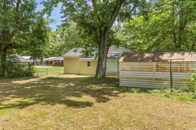 503 N Walnut St, Searcy, AR 72143 - view of yard featuring a storage unit and an outbuilding