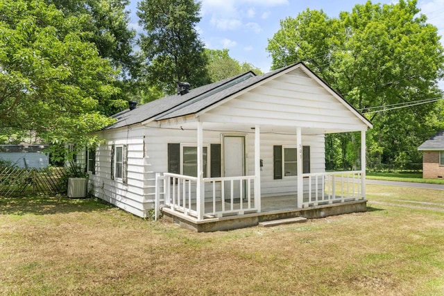 503 N Walnut St, Searcy, AR 72143 - back of property with a porch, a yard, cooling unit, and a shingled roof