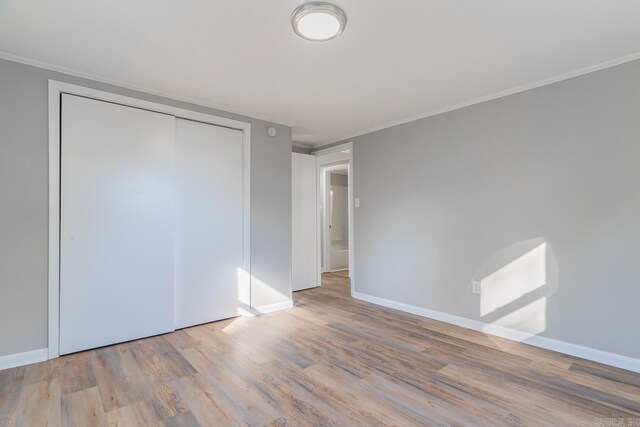 3907 Gamblin Dr, Jonesboro, AR 72404 - unfurnished bedroom featuring wood finished floors, baseboards, a closet, and ornamental molding