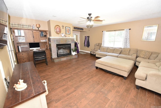 22 Primrose Ln, Greenbrier, AR 72058 - living room featuring dark wood-type flooring, a fireplace, a ceiling fan, and baseboards