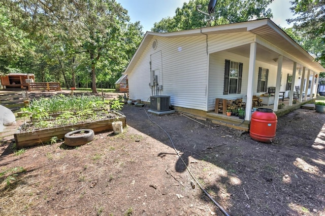 22 Primrose Ln, Greenbrier, AR 72058 - view of home's exterior featuring a vegetable garden, a porch, and central AC