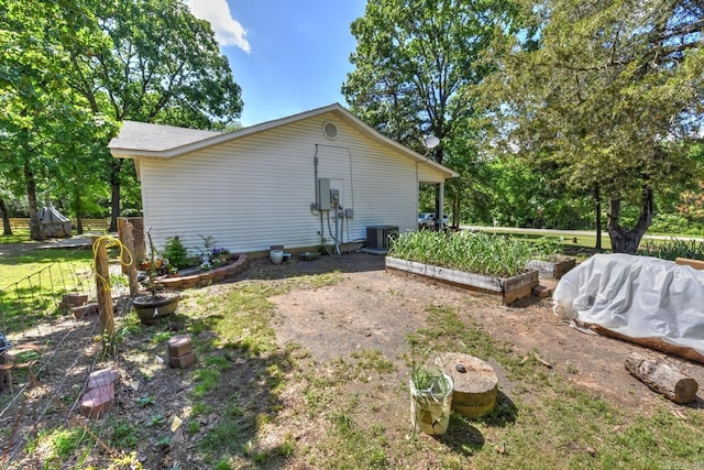 22 Primrose Ln, Greenbrier, AR 72058 - view of property exterior featuring a vegetable garden and central air condition unit