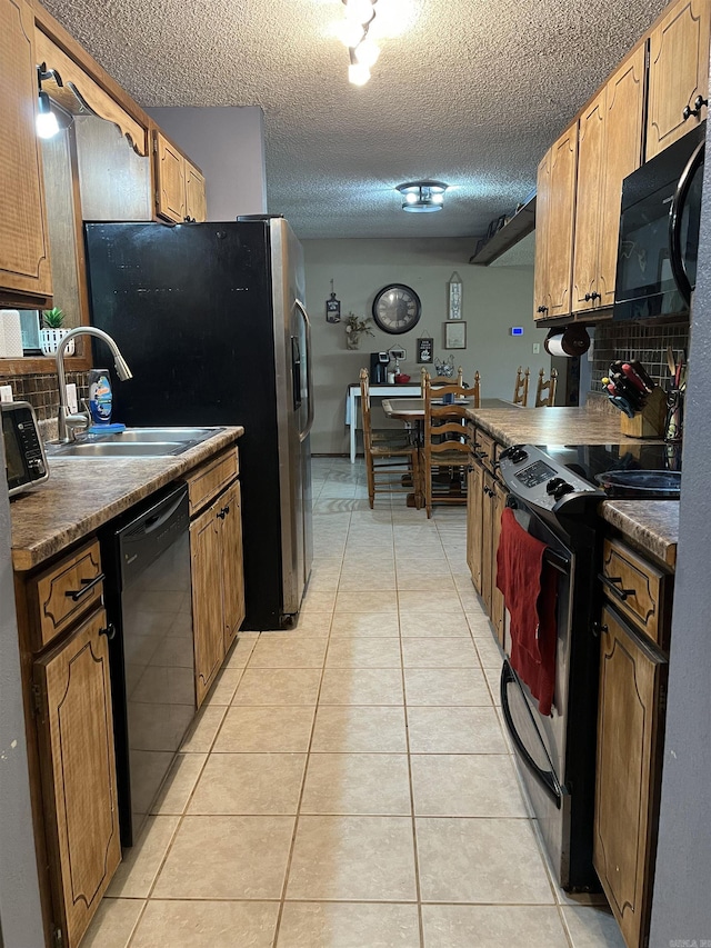 911 Apple Rd, Bonnerdale, AR 71933 - kitchen featuring black appliances, a sink, backsplash, light tile patterned floors, and a textured ceiling